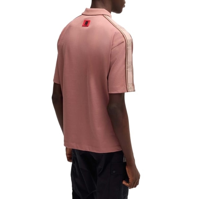 Mens Hugo X RB Branded Tape Polo Shirt in pink.- Polo collar.- One button placket.- Short sleeves.- Branded tape on the sleeves and a chest logo.- Relaxed fit.- Ref: 50530101689