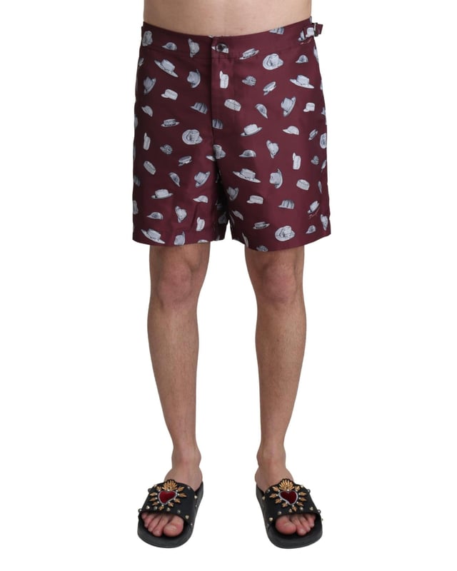 Absolutely stunning 100% Authentic exclusive brand new with tags
  Dolce &amp; Gabbana Beachwear swimming trunks
  2 inset front pockets
  1 zip rear pocket with hats print
  Modell: Swimshorts Trunks Boxer
  Color: Maroon
  Material: 100% Polyester
  Elastic waist strap
  Two front pockets and one back pocket
  Logo details
  Great fitting and comfort
Material: 100% Polyester