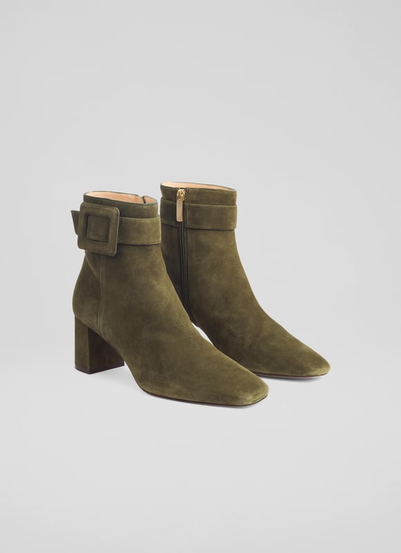 Step out in style with the charming Wilde buckle ankle boots, perfect for any smart-casual occasion. Featuring a covered buckle design in a rich green suede, these boots come with a comfortable block heel and a square toe, all lined with leather. Made in Spain. Pair them seamlessly with jeans or a stylish dress for a versatile and polished look.