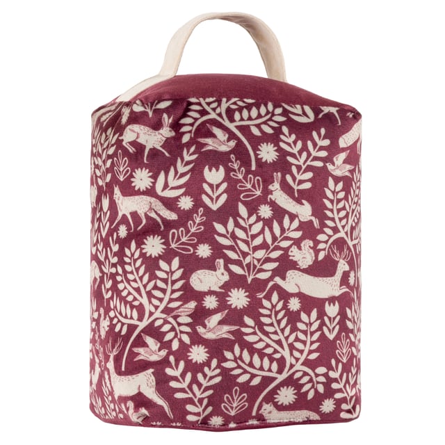 Take a trip to the Scandinavian woodland with this stunning doorstop. Featuring an intricate design of woodland animals from hares to foxes, intertwined with branches in a deep berry tone. This unique design is complemented with a plain velvet dye reverse and puts an ideal finishing touch to a Scandi-style or rustic interior.