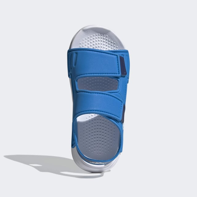 Sunscreen, check. Bucket hat, check. Blow-up unicorn? Maybe later. Let your aquanaut explore the shore in these kids' adidas sandals. Adjustable hook-and-loop straps create a snug fit that adds oomph as they skip stones. A grippy outsole leaves tracks in the sand as the sun sets on their perfect day.  - Regular fit - Hook-and-loop closure - EVA bandage upper - Textile lining - Contoured footbed - Lightweight EVA outsole  Shipped by adidas