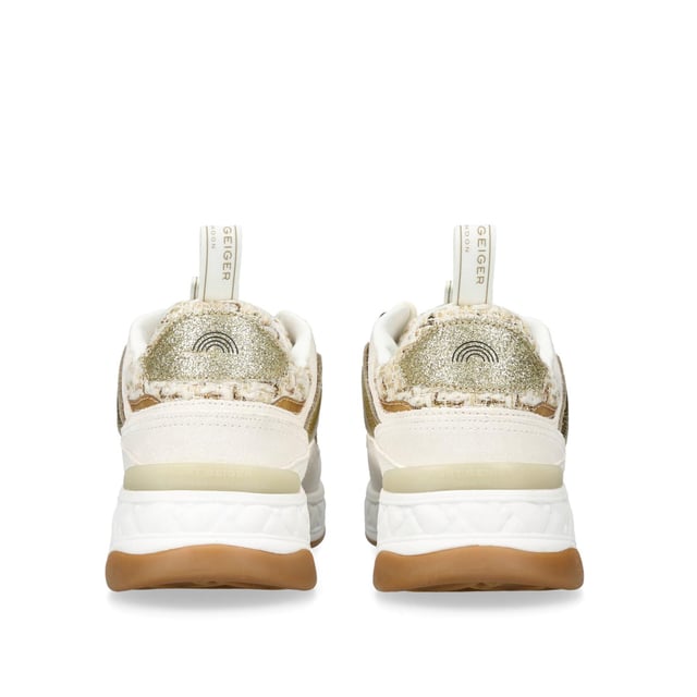 The Kurt Geiger London Kensington Sneaker features a multi-texture upper including crystal embellished houndstooth and suede eyestay. The tongue features a transparent branded monocle with antiqued brass Eagle head.