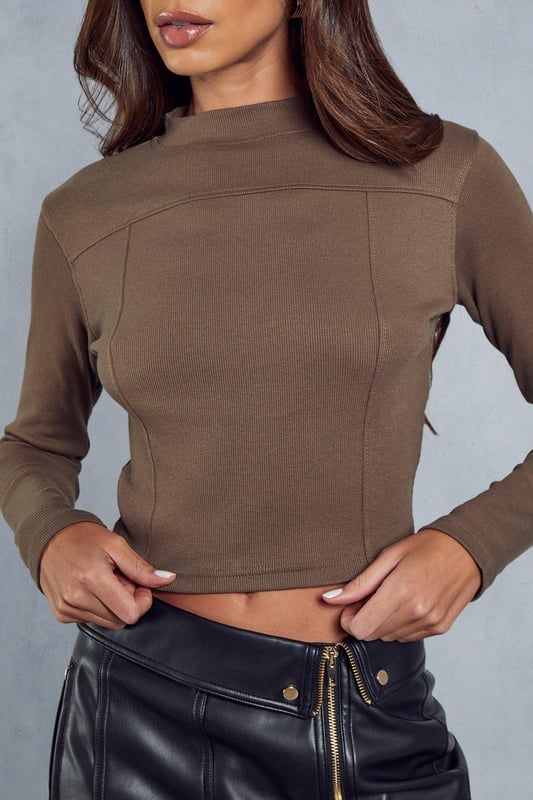 Ribbed fabric with textured detail 
 Long sleeves with fitted cuffs 
 Asymmetrical hemline for modern edge 
 Seam detailing adds visual interest 

This on-trend ribbed top from Misspap features an asymmetrical hem and seam detailing for a modern look. The ribbed fabric hugs the figure, while the long sleeves with fitted cuffs ensure a sleek silhouette. Pair this top with your favourite jeans or trousers for an effortlessly chic daytime look. For nighttime, dress it up with heels, a leather skirt and bold accessories for cocktails or a girl's night out. The versatile solid hue allows for creative mixing and matching with prints, patterns and colours.