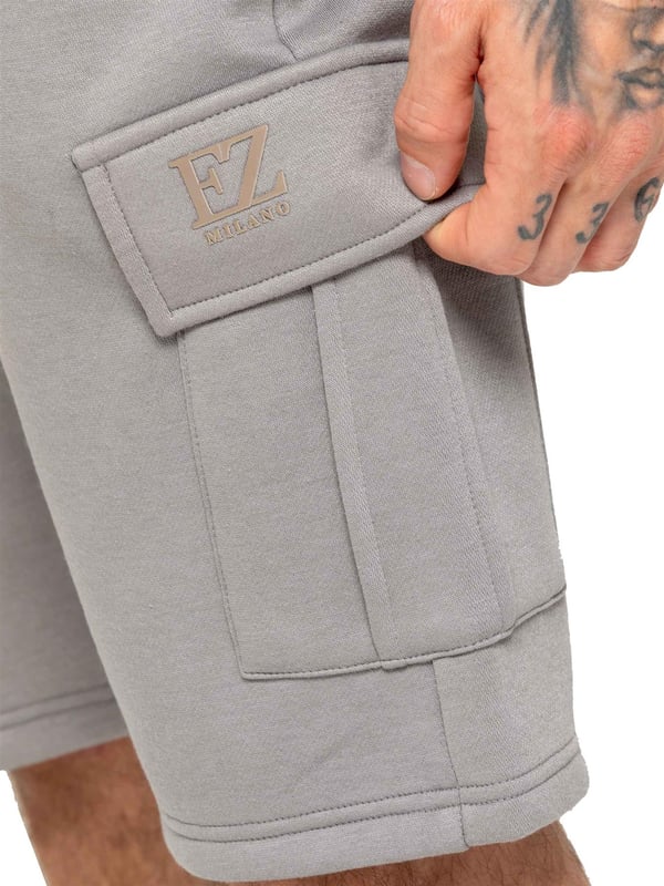 Experience comfort and style with Enzo's Men's Cargo Fleece Shorts. Made with brushed back inner fleece, these shorts offer a regular fit with 2 side pockets and 2 cargo pockets. The elasticated waistband, featuring the EZ logo, is adjustable with a drawstring for the perfect fit.
