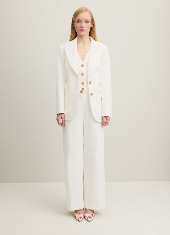 The perfect summer suit, the Avery jacket teams up with the matching waistcoat and trousers, but can also be worn to loosen up dresses or over jeans and a tee. Crafted in Portugal from beautiful Italian cotton in soft and textured cream, it has a straight cut, a wide, curved lapel, horn-effect buttons and large patch pockets to the front. Wear it with a pussy bow blouse and the Ami trousers or shrug it over a floral dress.