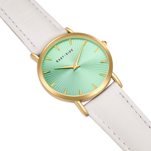 GENERAL INFORMATION:  • Targetgroup: Female  • Wristwatch: No Special Functions  • Display: analogue  • Weight of watch w/o box (gr.) - approx.: 27,0  MOVEMENT:  • Movement: Quartz  • Term of Movement: 2025  • Origin of movement: Japan  BRACELET:  • Material of bracelet/strap: Genuine leather  • Plating of bracelet/strap: None  • Finishing of bracelet/strap: Smooth  • Finishing/Decoration of bracelet/strap: Seam  • Clasp/Closure/Buckle: Buckle  • Color of bracelet/strap: White  • Length of bracelet/strap (mm) approx.: 190,0  • Width of bracelet/strap (mm) approx.: 18,0  • Style/Design of bracelet/strap: No imprint  • Bracelet/strap adjustable?: No  CASE:  • Shape of case: Round  • Size/Diameter of case in mm . approx.: 33,0  • Height of case in mm: 6,7  • Case material: Metal (Alloy)  • Surface of case: Polished  • Bezel/Topring: Fixed  • Finishing/Decoration of case: None  • Material of case back: Stainless steel  • Lock of case back: No screwed-in crown  • Color of case: Yellowgold  • Coating/Plating (Case): Ion-Plating (IP)  • Type/Form of crystal: Flat  • Material of crystal: Mineral crystal  • Water resistant (ATM): 3  DIAL:  • Size jewelry care cloth: Hour, Minute  • Indices: Line indices  • Material of dial: Brass  • Structure/pattern of dial: sunray  • Color of dial: Turquoise  PUSHER, CROWN, HAND:  • Pusher: None  • Corrector: No  • Crown: No screwed-in crown  • Type of hands: Dauphine hands  • Luminescent (hands): No  PACKAGING & SCOPE OF DELIVERY:  • Box: Yes  • Service booklet: Yes  • Manual: Yes