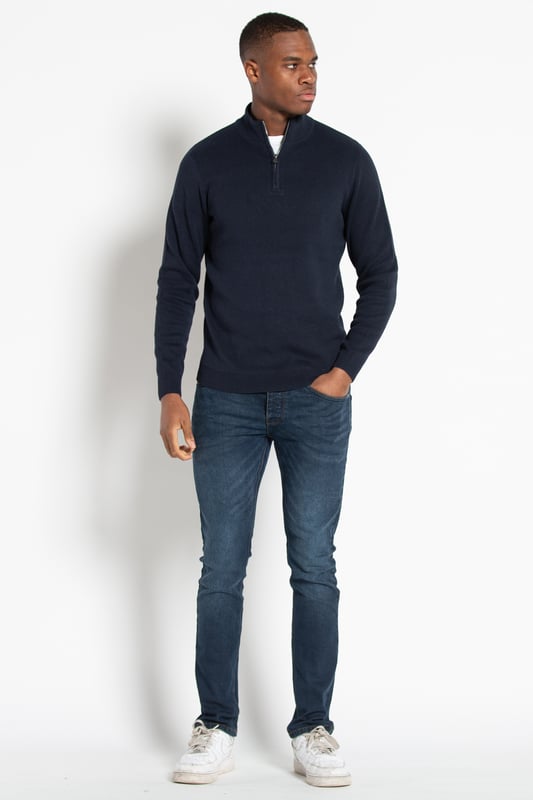 This 1/4 zip jumper from Kensington Eastside is a wardrobe essential. This jumper features ribbed elasticated details on the 1/4 zip funnel neck, cuffs, and hem. This jumper is made from cotton blend fabric, ensuring comfortability and warmth.