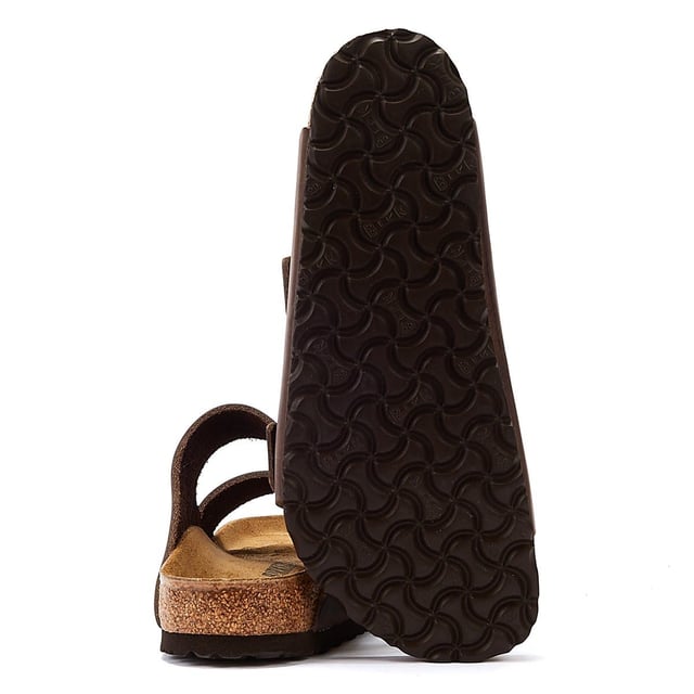 Birkenstock Arizona Habana Unisex Sandals The Birkenstock Arizona SFB Unisex Tabaco Brown Sandals are sandals feature two adjustable straps with metallic buckles that can be customized to fit the foot comfortably.The upper material is made of oiled nubuck leather which is durable and easy to maintain. The leather also has a soft velvety texture that feels comfortable against the skin. The footbed of the Birkenstock Arizona SFB Sandals is made of the brand's signature cork-latex material which is anatomically shaped to support the foot's natural contours. The footbed also has a deep heel cup a roomy toe box and a suede lining that helps wick away moisture keeping the feet cool and dry. The sole of the Birkenstock Arizona SFB Sandals is made of EVA a lightweight and flexible material that provides cushioning and shock absorption.