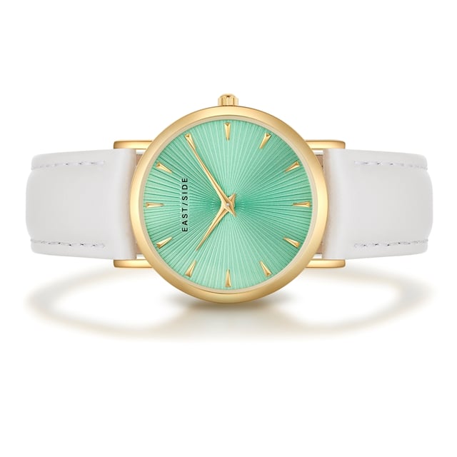 GENERAL INFORMATION:  • Targetgroup: Female  • Wristwatch: No Special Functions  • Display: analogue  • Weight of watch w/o box (gr.) - approx.: 27,0  MOVEMENT:  • Movement: Quartz  • Term of Movement: 2025  • Origin of movement: Japan  BRACELET:  • Material of bracelet/strap: Genuine leather  • Plating of bracelet/strap: None  • Finishing of bracelet/strap: Smooth  • Finishing/Decoration of bracelet/strap: Seam  • Clasp/Closure/Buckle: Buckle  • Color of bracelet/strap: White  • Length of bracelet/strap (mm) approx.: 190,0  • Width of bracelet/strap (mm) approx.: 18,0  • Style/Design of bracelet/strap: No imprint  • Bracelet/strap adjustable?: No  CASE:  • Shape of case: Round  • Size/Diameter of case in mm . approx.: 33,0  • Height of case in mm: 6,7  • Case material: Metal (Alloy)  • Surface of case: Polished  • Bezel/Topring: Fixed  • Finishing/Decoration of case: None  • Material of case back: Stainless steel  • Lock of case back: No screwed-in crown  • Color of case: Yellowgold  • Coating/Plating (Case): Ion-Plating (IP)  • Type/Form of crystal: Flat  • Material of crystal: Mineral crystal  • Water resistant (ATM): 3  DIAL:  • Size jewelry care cloth: Hour, Minute  • Indices: Line indices  • Material of dial: Brass  • Structure/pattern of dial: sunray  • Color of dial: Turquoise  PUSHER, CROWN, HAND:  • Pusher: None  • Corrector: No  • Crown: No screwed-in crown  • Type of hands: Dauphine hands  • Luminescent (hands): No  PACKAGING & SCOPE OF DELIVERY:  • Box: Yes  • Service booklet: Yes  • Manual: Yes