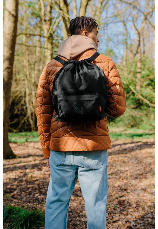 A medium-sized drawstring backpack made in crushed nylon fabric. This practical everyday backpack has plenty of space and multiple pockets for you to organise your essentials. Its lightweight and stylish design will complement any outfit. Ideal for heading to school, daily commuting or a weekend away. Features: , Artsac rubberised patch logo, Drawstring opening, Adjustable shoulder straps, Exterior front and back zipped pocket, Internal zip and slip pockets, Splash proof crushed nylon Style Ref: 50295 BLACK