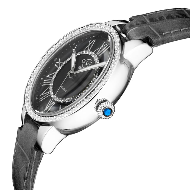 Named after Manhattan’s famed Astor Place, known for its culture and creativity, the Astor II collection elevates drama to high art. With the Astor’s signature 38mm diamond-encrusted bezel comprised of fifty genuine diamonds and distinctive blue cabochon gemstone crown, the Astor II is not to be outdone boasting a show-stopping mother of pearl face. In brilliant black, blue or white mother of pearl, the distinguished Astor II ups the ante with four single cut diamonds encircling a 12-diamond studded inner circle. In Rose, Yellow Gold or Silver Stainless Steel bracelet, elegance has a new name. Heighten drama and elevate intrigue with the stunning Astor II collection: easy to appreciate and hard to ignore.
GV2 9143-L7 Women's Astor II Swiss Diamond Watch
GV2 Women's Swiss Watch from the Astor II Collection
38mm 316L Stainless Steel Case, Diamond Cut Bezel
Brilliant Black MOP Dial with White Indices, 4 Single Cut Diamonds on Dial, with diamond-cut inner circle
Push Pull Fluted crown with Blue cabochon Stone
Genuine Handmade Black Italian Leather Strap with Tang Buckle
Anti-reflective Sapphire Crystal
Water Resistant to 30 Meters/3ATM
Swiss Quartz Movement Ronda 1069