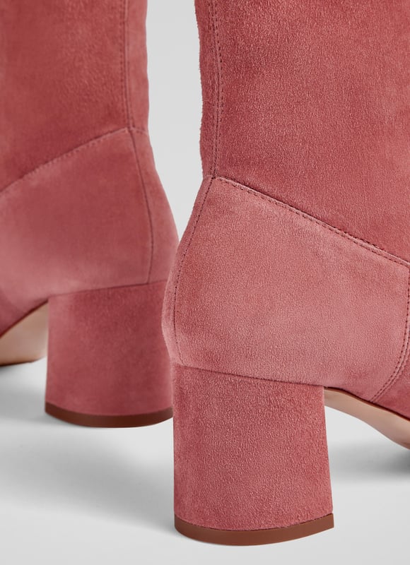Step confidently into any occasion with the Harp block heel stretch ankle boots in a captivating rose hue. Made in Italy from sustainable stretch suede, these boots feature a stylish square toe and a sturdy block heel, perfect for smart or casual wear. Pair them effortlessly with tailored trousers or your favourite midi skirt.