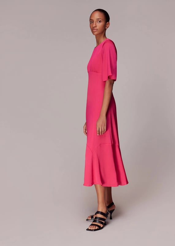 Embrace elegance with the Alana Satin Dress, a stunning pink midi perfect for any soirée. Crafted from 100% recycled polyester, this eco-conscious piece features a chic cut-out design and short sleeves. Its flowing silhouette ensures a flattering fit for all, making it an ideal choice for your next evening out.