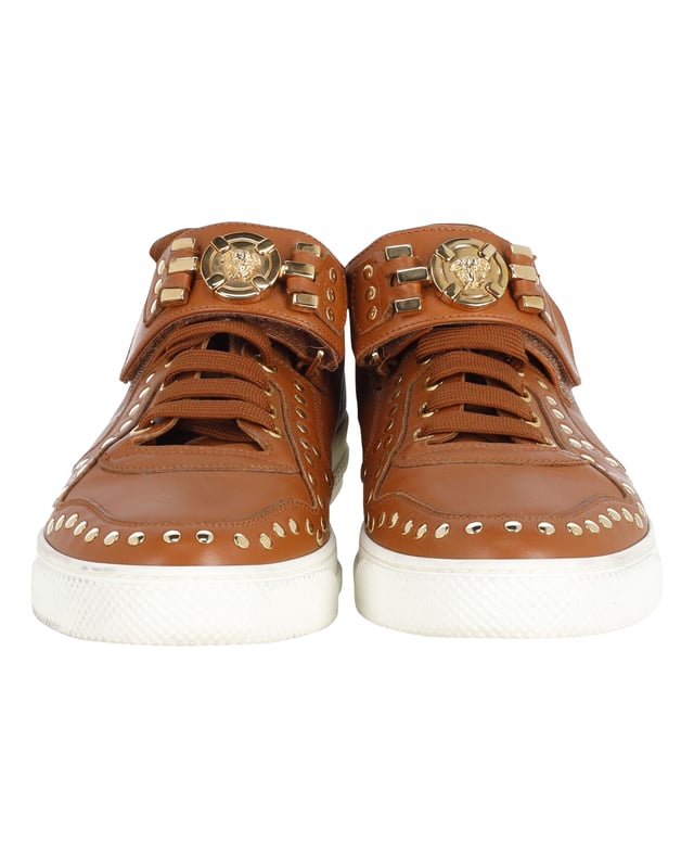 VINTAGE, RRP AS NEW
Brimming with fabulous details, these Versace sneakers are crafted from leather into a low-top silhouette and feature lace-up vamps, gold-tone studs and the Medusa logo on the ankle straps. Comfortable soles and trendy appeal make these sneakers a must-buy.
Versace Medusa Studded Low Top Sneakers in Tan Leather
Condition: very good
Sign of wear: light dirt on soles, minimal creasing on exterior
SKU: 245398   
Color: brown | tan
Material: Leather
Size: IT40/EU40/UK7/US10