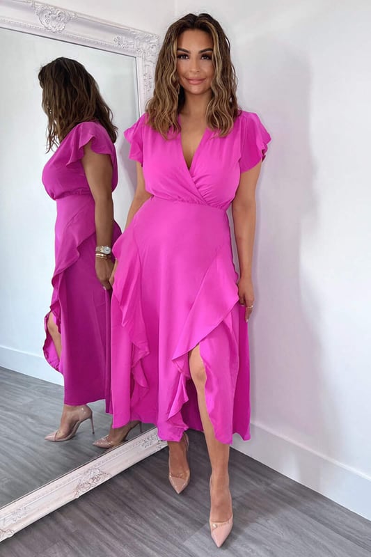 Our Cerise Frill Detail Double Split Skirt Midi Dress is right on trend this season! Featuring a v neck wrap top, short frill sleeves, a frill detail double split skirt and a zip up back.  Style with heels and a matching bag.   Model wears: UK 8/ EU 36/ US 4 Model's height: 165cm/ 5'5" Approx length from centre back to hem: 134cm Fabric composition: 100% Polyester Colour: CERISE