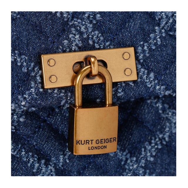 The Kurt Geiger Brixton Lock Bag is crafted from a denim with frayed quilted design. There is an antiqued brass branded padlock on the front flap. 17cm (H), 26cm (L), 8cm (D) Strap drop cross body: 108cm Strap drop shoulder: 65cm