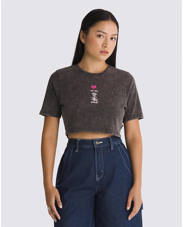The Heartbreaker Crew Crop T-Shirt is a short sleeve cropped crewneck tee with the Vans logo and features an allover gravel wash and a graphic print of a broken heart and flower on the front. 100% Cotton fabric   Short sleeve crop top crew neck T-shirt   Sceenprinted graphic with puff ink   Gravel wash   Model wearing size Small