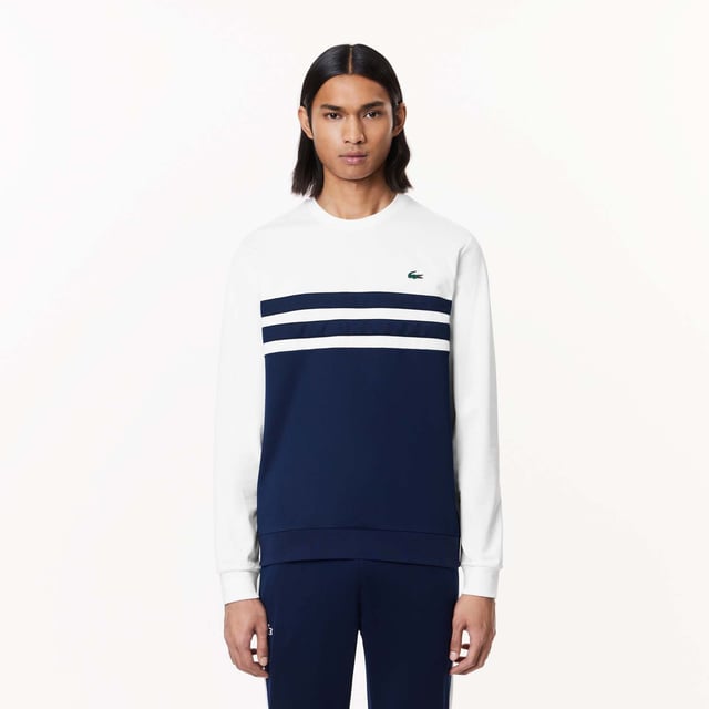 Designed for Tennis  for a regular frequency of use This product is in Interlock which guarantees you a resistant fabric making it adapted to high repetitive movements during training sessions. This sweatshirt is made in 100% recycled polyester Classic fit: comfortable ease on body  with comfortable sleeves The technical capsule offers the complete seasonal wardrobe on and off court with a strong design identity. LACOSTE wording print at back neckline.