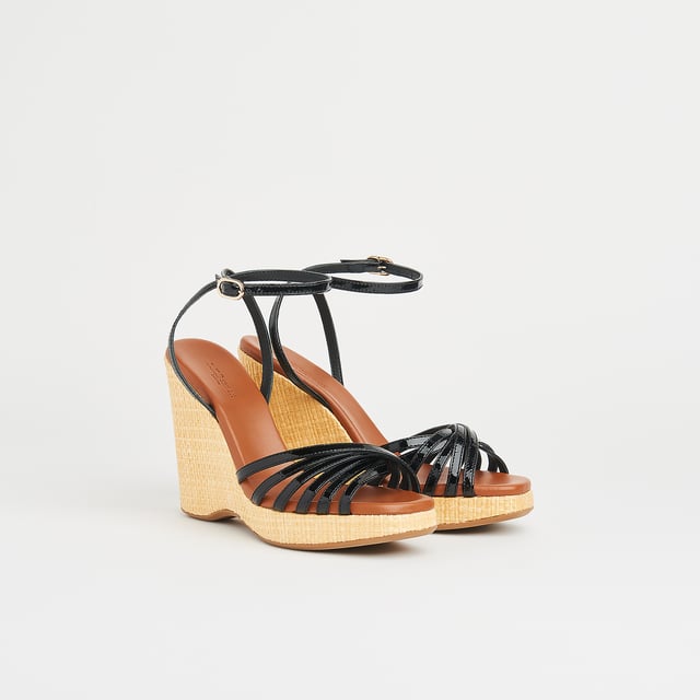 LK Bennett SOLANGE Sandals, Black With a hint of Seventies' playfulness, our Solange wedges balance height and comfort. Crafted in Italy from black patent leather, they have a crossover multi-strap design, a delicate ankle strap and a beige raffia 110mm wedge sole. Perfect with summer's cool cotton and linen skirts and dresses, they're also great with wide leg trousers.