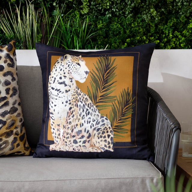 Elevate your outdoor space with the Leopardis Cat Outdoor Cushion, where artistry meets functionality. Designed with a subtly refined texture, the soft-touch material has been specially treated for outdoor durability. This water-resistant cushion is easy to wipe clean, making it as practical as it is elegant. Its hand-painted motif is set against a backdrop that beautifully complements any outdoor setting. Complete with a sleek contrasting border, this luxe cushion lends an air of sophistication and detail, ensuring it stands out as a statement piece while harmonising with your stylish outdoor décor.