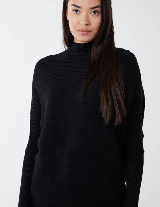 What do we want in Winter? We want to be warm, comfortable and yes€¦ the best we can look anywhere we go. Which why our highly elasticated batwing jumper with a high neckline is a close friend of ours. It's here when we go to work, a casual weekend, or a night out. And it puts us in a particularly good mood when styled with a pleated skirt and high knee boots.