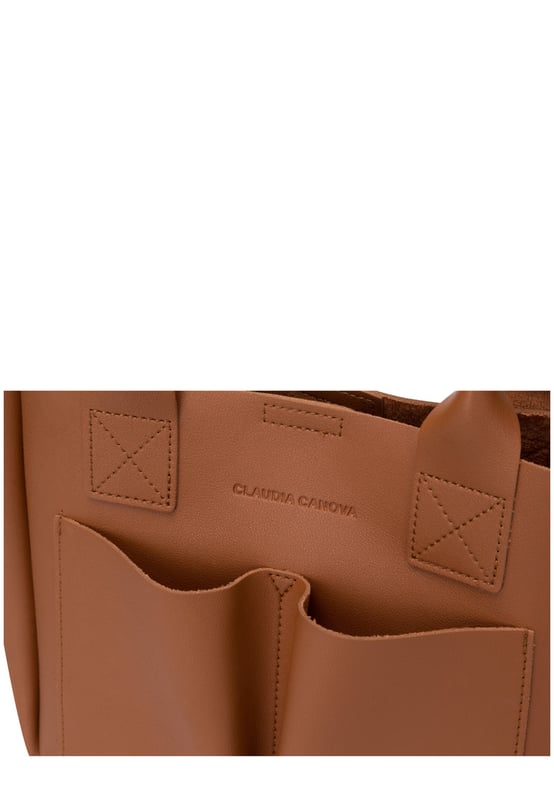 This dreamy mini grab bag is perfect for adding a contemporary look to your outfit. The soft PU exterior and contrast unlined interior gives it a premium finish and the gunmetal hardware adds quality. The subtle Claudia Canova blind debossed logo and intricate stitch detail finishes the look. Inside is a secure zip top pouch, which can be removed by unfastening the snap clasp buttons, perfect to use as a portable makeup bag or to keep valuable items more secure. Features: , soft pu outer, Unlined Interior, Claudia and Canova Blind Deboss Logo, 2 x Short Grab / Tote Handles, Adjustable longer shoulder strap, Magnetic snap claps opening to the main compartment, Removable zip top pouch (Meausure 215W x 152H x 50D), 2 x Quick access slip pockets in front Style Ref: 84608 TAN