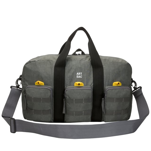 The ultimate carry companion, perfect for every day wear. Featuring a full-length zip top opening and 3 large side pockets, the Haring Triple Holdall is spacious enough for any short or long trip away. Features a detatchable shoulder strap. Features: , Water Resistant, 15 inch padded laptop sleeve - Fits Apple MacBook Pro 16 inch, Grab handle carry straps, Removable shoulder strap allowing crossbody styling, Zip top opening to main compartment, Triple front zip pocket with webbing loops Single zip pocket for smaller valuables, Internal zip pocket, 2 Internal mobile phone slip pockets - Fits normal and plus size smart phones, 3 Internal pen slip pockets, External rear zip pocket Style Ref: 52004 GREY