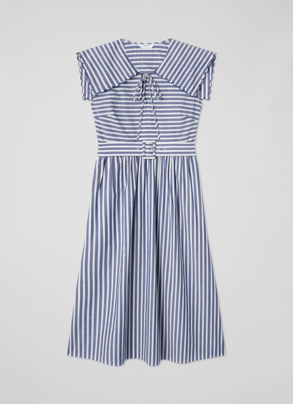 A chic sun dress which takes design cues from sailor style, beautiful Beau is destined for glamorous destinations. It's crafted from blue and cream striped cool cotton, and has a wide scalloped edge collar with tie detail, a fabric-covered buckle belt and an A-line midi skirt. Wear it with a pair of leather sandals and a basket bag.
