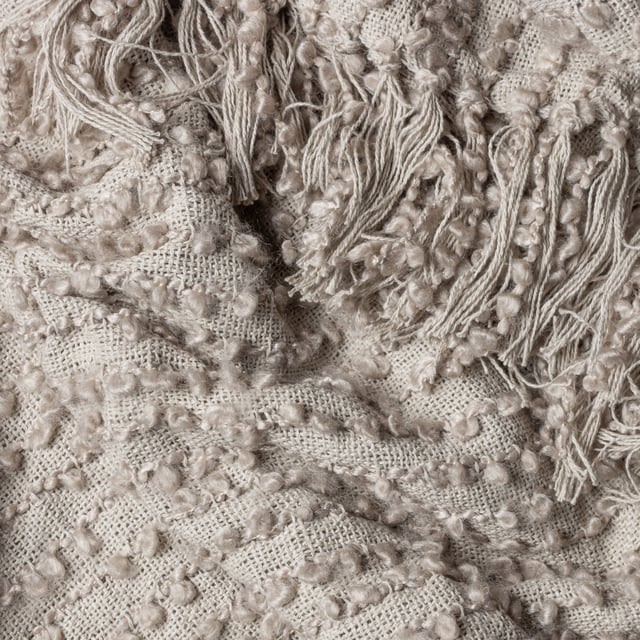 Add instant style and texture to any space with the Arvo throw. This woven design is adorned with elegant strands of vertical boucle yarn, which slide gracefully down the piece, until they meet the textural fringing at both ends. It comes in a range of muted, chic tones, which are inspired by modern neutrals and fashion fabrics. A simple, but polished throw to drape on your sofa or bed to add instant style and texture to your home.