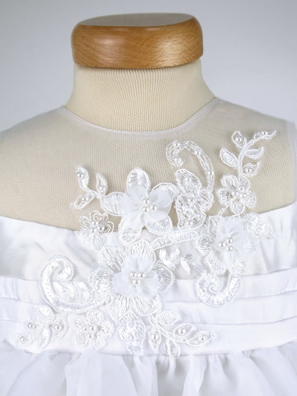 ROSIE by Heritage, is another one of our stunning special occasion dresses using fabric that has been sourced from Japan.
It has a delicate organza fabric section over the shoulders and around the neck, making it almost invisible from a distance.
The body is made from our popular 'mock silk' with pin tucks around the waist. We then added a guipure lace flower shape panel over the top that has been hand finished with organza flowers and pearl beads.
The skirt has net layers underneath creating a lovely full princess like shape. Perfect for twirling at any given moment, as long as they're not walking down the Aisle behind the bride at the time.  Perfect for parties though ;)
The back of the dress has a long sash to tie a large bow and has a back zip fastening.
It's lined in 100% soft cotton lawn fabric so it is soft against the child's skin and keeps them cool.
 
The dress comes to you on a padded satin hanger and protected in a Heritage keepsake bag.
This beautiful ROSIE white dress is ideal for Christenings, Baptisms, Flower girl dress or any other special occassion! Team it up with our VALENTINA cardigan in white and you're ready to wow your friends and relatives! Kodak moment
 
Outer - 100% Polyester White (mock silk and Organza)
Lining - 100% cotton
Hand wash or Dry clean only