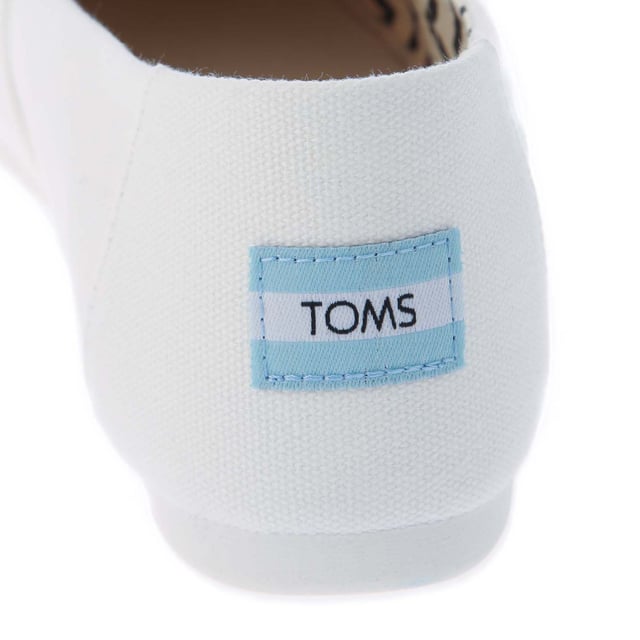 Womens Toms Recycled Cotton Canvas Alpargata Espadrille Pumps in white.- Recycled cotton upper  lining and sock-liner made with 50% recycled cotton.- Classic Alpargata design.- Toe-stitch and elastic V for easy on and off.- Chevron patterned canvas lining.- Custom insoles made with 50% eco content including recycled PU foam.- Direct injection outsole for flexibility and durability with tread pattern for improved traction.- Toms branding to side and back of heel.- 100% vegan construction.- Textile upper  Textile lining  Synthetic and textile sole.- Ref:10017739