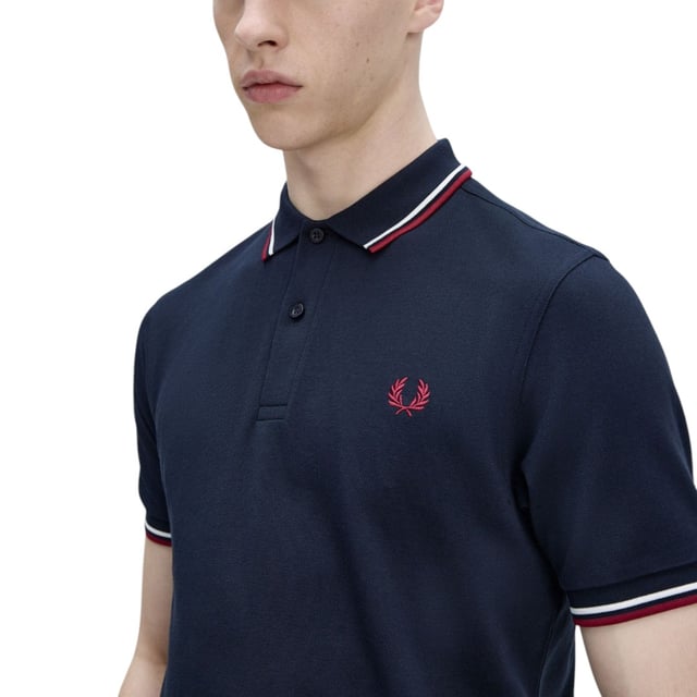 The Twin Tipped Fred Perry Polo Shirt by Fred Perry is a short sleeved polo shirt that has been made from Fred Perry's classic cotton piqué, in a contemporary adaptation of Fred's famous streamlined fit. Available in a diverse range of colourways - each with their own unique story. Featuring the signature Fred Perry wreath logo to the chest and twin tipping to the collar and cuffs.