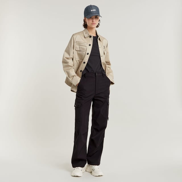 Zip fly. Inset pockets. Welt pockets at the back. Thigh pockets with additional flap pockets on top, snap buttons. Key ring at one of the thigh pockets. Zip & button closure. Ultra-high waist. Cargo pants High Waist are designed in a straight fit and offer an ultra-high waist. Pleats at the outer leg add more shape to this design. The pockets at the thigh show additional flap pockets on top. A key ring is added to one side. 65% Polyester (Recycled), 35% Elastomultiester. Comfortable stretch. Straight