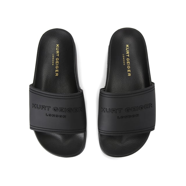 This Kurt Geiger drench Pool slider sandal is crafted from a black rubber. The wide foot strap is embellished with Kurt Geiger branding and the footbed is moulded for comfort.