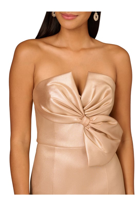 Foiled stretch Mikado, strapless notch neckline featuring a bodice bow detail, mermaid skirt and back zipper
