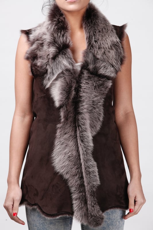 A high-quality garment that is perfect for maintaining an elegant look whilst keeping warm during the colder months. This gilet is extended in length and features our premium Spanish Toscana sheepskin, which is renowned for being amongst the warmest and most comfortable wools in the world. The soft woollen lining can either be concealed with a hook and eye fastening or exposed at the front opening in a distinctive waterfall design for an extravagant look, making it the perfect piece for adding a touch of elegance to your winter outfits. • Exclusively manufactured in the UK using double faced Toscana sheepskin • Toscana sheepskin lining is unparalleled in providing warmth and comfort • Exterior and interior painstakingly crafted for a soft silky finish • Length of 30”