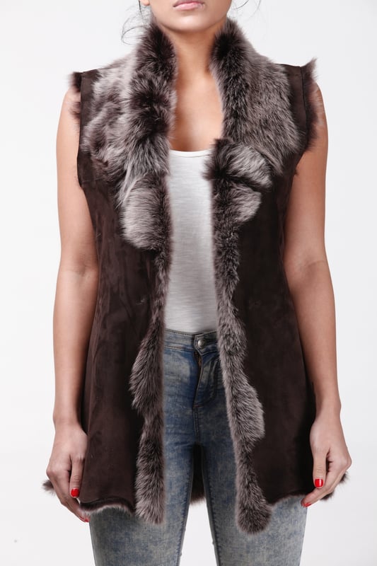 A high-quality garment that is perfect for maintaining an elegant look whilst keeping warm during the colder months. This gilet is extended in length and features our premium Spanish Toscana sheepskin, which is renowned for being amongst the warmest and most comfortable wools in the world. The soft woollen lining can either be concealed with a hook and eye fastening or exposed at the front opening in a distinctive waterfall design for an extravagant look, making it the perfect piece for adding a touch of elegance to your winter outfits. • Exclusively manufactured in the UK using double faced Toscana sheepskin • Toscana sheepskin lining is unparalleled in providing warmth and comfort • Exterior and interior painstakingly crafted for a soft silky finish • Length of 30”