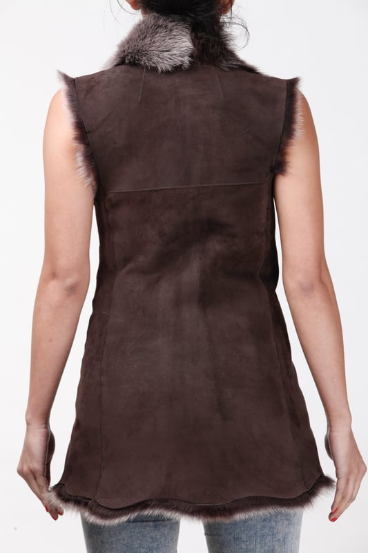 A high-quality garment that is perfect for maintaining an elegant look whilst keeping warm during the colder months. This gilet is extended in length and features our premium Spanish Toscana sheepskin, which is renowned for being amongst the warmest and most comfortable wools in the world. The soft woollen lining can either be concealed with a hook and eye fastening or exposed at the front opening in a distinctive waterfall design for an extravagant look, making it the perfect piece for adding a touch of elegance to your winter outfits. • Exclusively manufactured in the UK using double faced Toscana sheepskin • Toscana sheepskin lining is unparalleled in providing warmth and comfort • Exterior and interior painstakingly crafted for a soft silky finish • Length of 30”