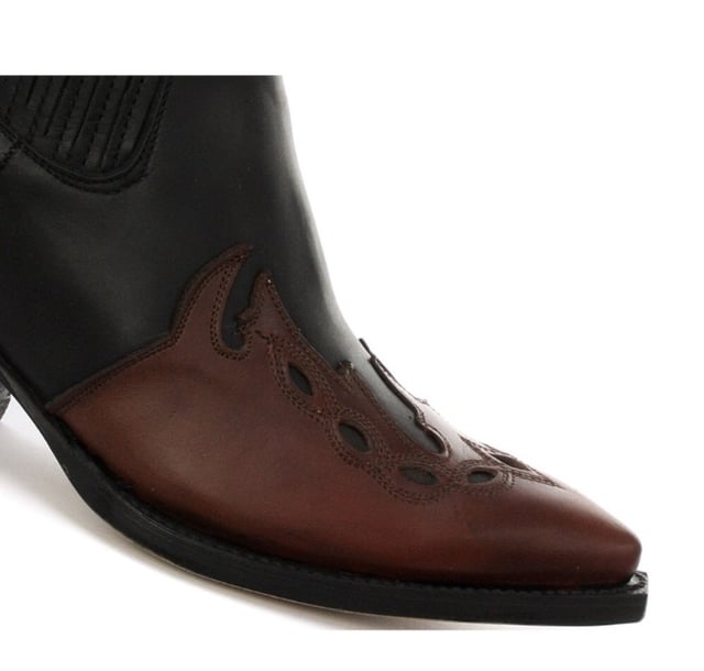 This boot is a shorter version of the Grinders ‘Arizona’ cowboy style and has been reimagined in a classic Cuban heeled Chelsea boot. The upper is made of high-quality leather and a stylish leather overlay appears on the pointed toe with a convenient elasticated gusset and pull loops implemented at the boot opening. The interior is crafted from soft leather which cushions the foot and allows for breathability. The underside of the shoe displays a stacked 1.5” heel which is built onto a durable welted leather sole that has been engraved with the iconic Grinders Bulldog logo. • Goodyear Welted • Leather upper • Soft Leather lining • Stacked leather heels • Leather Soles • Made in Mexico
