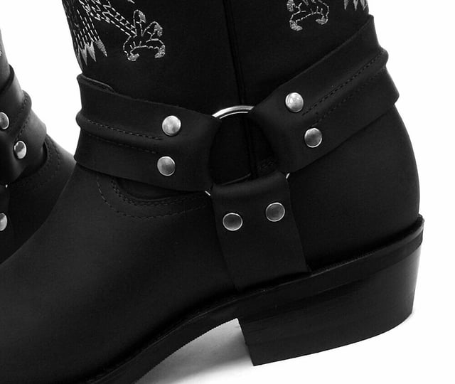 This bald eagle style pairs a vintage cowboy silhouette with an eye-catching design and imparts it upon a hard wearing and durable boot. The boot upper is crafted from leather and is embossed with a colour contrasting embroidered eagle design which is stitched onto the front and back. Additionally, a three-way ankle harness with riveted brass rings is wrapped around the boot and imbues it with extra unique quality. Other introductions to this shoe include a square toe front, comfortable leather lining, a stacked 1.5” Cuban heel and embossed branding on the outer sides. For an added durable quality, the sole of this boot is welted using the Goodyear method, which is known for providing strength and long last to shoes. • High Leg Harness Boots • Goodyear Welted sole • Shoe upper is crafted from premium leather • Features a soft leather lining • Rubber soles • Made in Mexico