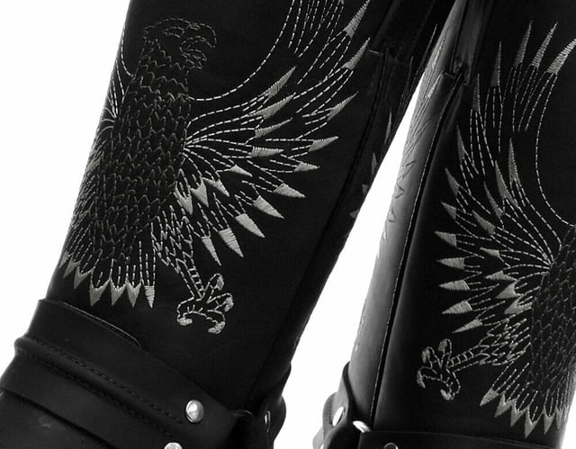 This bald eagle style pairs a vintage cowboy silhouette with an eye-catching design and imparts it upon a hard wearing and durable boot. The boot upper is crafted from leather and is embossed with a colour contrasting embroidered eagle design which is stitched onto the front and back. Additionally, a three-way ankle harness with riveted brass rings is wrapped around the boot and imbues it with extra unique quality. Other introductions to this shoe include a square toe front, comfortable leather lining, a stacked 1.5” Cuban heel and embossed branding on the outer sides. For an added durable quality, the sole of this boot is welted using the Goodyear method, which is known for providing strength and long last to shoes. • High Leg Harness Boots • Goodyear Welted sole • Shoe upper is crafted from premium leather • Features a soft leather lining • Rubber soles • Made in Mexico