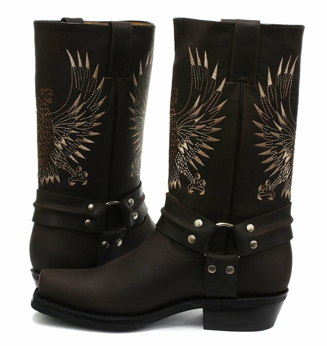 This bald eagle style pairs a vintage cowboy silhouette with an eye-catching design and imparts it upon a hard wearing and durable boot. The boot upper is crafted from leather and is embossed with a colour contrasting embroidered eagle design which is stitched onto the front and back. Additionally, a three-way ankle harness with riveted brass rings is wrapped around the boot and imbues it with extra unique quality. Other introductions to this shoe include a square toe front, comfortable leather lining, a stacked 1.5” Cuban heel and embossed branding on the outer sides. For an added durable quality, the sole of this boot is welted using the Goodyear method, which is known for providing strength and long last to shoes. • High Leg Harness Boots • Goodyear Welted sole • Shoe upper is crafted from premium leather • Features a soft leather lining • Rubber soles • Made in Mexico