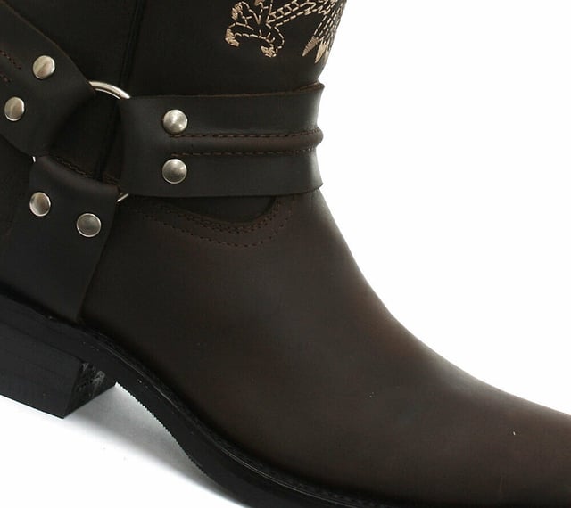 This bald eagle style pairs a vintage cowboy silhouette with an eye-catching design and imparts it upon a hard wearing and durable boot. The boot upper is crafted from leather and is embossed with a colour contrasting embroidered eagle design which is stitched onto the front and back. Additionally, a three-way ankle harness with riveted brass rings is wrapped around the boot and imbues it with extra unique quality. Other introductions to this shoe include a square toe front, comfortable leather lining, a stacked 1.5” Cuban heel and embossed branding on the outer sides. For an added durable quality, the sole of this boot is welted using the Goodyear method, which is known for providing strength and long last to shoes. • High Leg Harness Boots • Goodyear Welted sole • Shoe upper is crafted from premium leather • Features a soft leather lining • Rubber soles • Made in Mexico