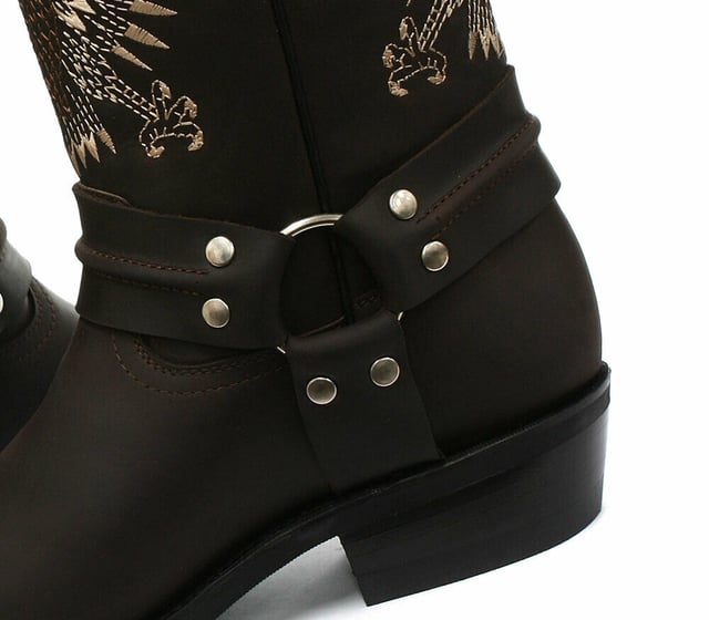 This bald eagle style pairs a vintage cowboy silhouette with an eye-catching design and imparts it upon a hard wearing and durable boot. The boot upper is crafted from leather and is embossed with a colour contrasting embroidered eagle design which is stitched onto the front and back. Additionally, a three-way ankle harness with riveted brass rings is wrapped around the boot and imbues it with extra unique quality. Other introductions to this shoe include a square toe front, comfortable leather lining, a stacked 1.5” Cuban heel and embossed branding on the outer sides. For an added durable quality, the sole of this boot is welted using the Goodyear method, which is known for providing strength and long last to shoes. • High Leg Harness Boots • Goodyear Welted sole • Shoe upper is crafted from premium leather • Features a soft leather lining • Rubber soles • Made in Mexico