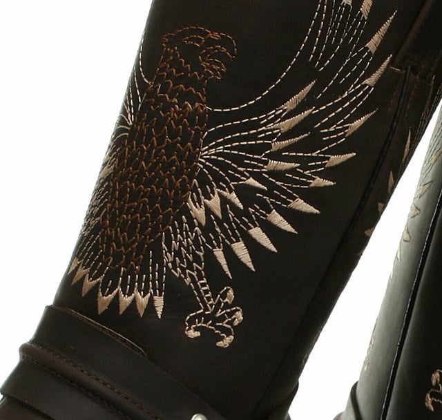 This bald eagle style pairs a vintage cowboy silhouette with an eye-catching design and imparts it upon a hard wearing and durable boot. The boot upper is crafted from leather and is embossed with a colour contrasting embroidered eagle design which is stitched onto the front and back. Additionally, a three-way ankle harness with riveted brass rings is wrapped around the boot and imbues it with extra unique quality. Other introductions to this shoe include a square toe front, comfortable leather lining, a stacked 1.5” Cuban heel and embossed branding on the outer sides. For an added durable quality, the sole of this boot is welted using the Goodyear method, which is known for providing strength and long last to shoes. • High Leg Harness Boots • Goodyear Welted sole • Shoe upper is crafted from premium leather • Features a soft leather lining • Rubber soles • Made in Mexico