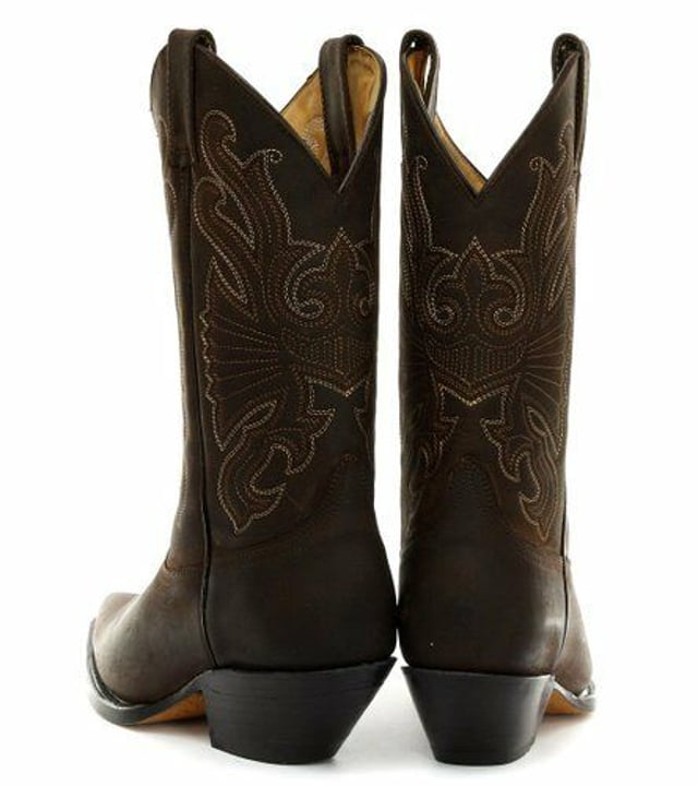 The Grinders Buffalo is a quality, hard wearing all leather western cowboy boot. This style features a brown oiled upper which is abrasion resistant for longer wear and sports a colour contrasting stitched detailed pattern on the shaft. This boot is given an iconic Western style with introductions such as a pointed toe and 2.25-inch stacked Cuban heel and is made comfortable using a full leather lining and insole. The branded genuine leather sole unit provides greater durability and the two side pull on loops makes the boots easier to put on, all of which add to the comfort and practicality of this stylish luxury Buffalo boot. • Goodyear Welted sole • Leather upper with detailed stitched design • Soft Leather lining • Stacked 2.25” Cuban heels • Leather Soles • Made in Mexico