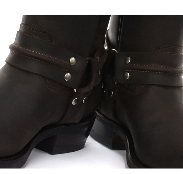 Esta elegante bota de cuero tiene una silueta de caña alta y presenta un diseño de arnés de tres piezas con detalles de tachuelas que envuelve la bota y está conectada por un anillo de metal. El diseño sin cordones de estos zapatos se ve mejorado por el uso de presillas de marca para calzar y refuerzos elásticos dobles cosidos en los lados que hacen que estas botas sean fáciles de poner y quitar. Para una calidad más duradera, la suela de esta bota está cosida con el método Goodyear, que es conocido por brindar resistencia y durabilidad a los zapatos. • Botas de arnés de caña alta • Suela cosida Goodyear • La parte superior del zapato está hecha de cuero de primera calidad • Cuenta con un forro de cuero suave • Suelas de goma • Fabricado en México