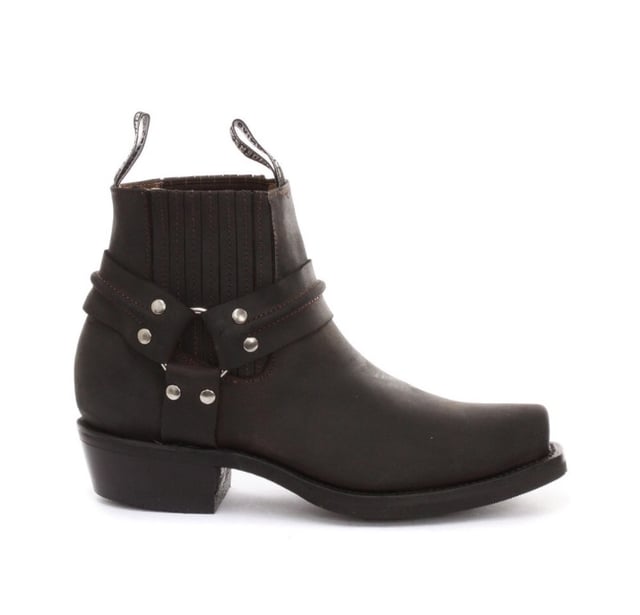 This classy leather boot appears in a low leg silhouette and features a stud detailed tri harness design that wraps around the boot and is connected by a metal ring. The slip-on design of these shoes is enhanced by the use of branded pull-on loops and stitched twin side elasticated gussets that make these boots easy to get on and off. For an added durable quality, the sole of this boot is welted using the Goodyear method, which is known for providing strength and long last to shoes. • Low Leg Harness Boots • Goodyear Welted sole • Shoe upper is crafted from premium leather • Features a soft leather lining • Rubber soles • Made in Mexico