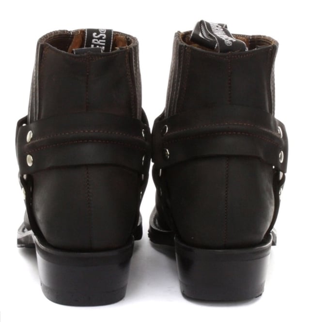 This classy leather boot appears in a low leg silhouette and features a stud detailed tri harness design that wraps around the boot and is connected by a metal ring. The slip-on design of these shoes is enhanced by the use of branded pull-on loops and stitched twin side elasticated gussets that make these boots easy to get on and off. For an added durable quality, the sole of this boot is welted using the Goodyear method, which is known for providing strength and long last to shoes. • Low Leg Harness Boots • Goodyear Welted sole • Shoe upper is crafted from premium leather • Features a soft leather lining • Rubber soles • Made in Mexico