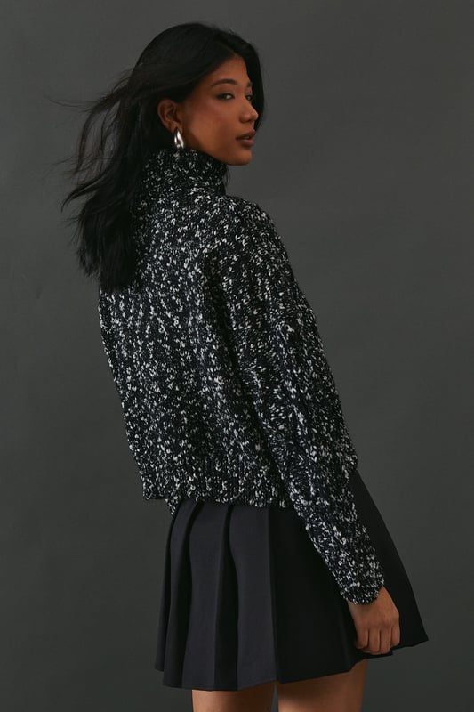 Intricate cable knit pattern for a textured look
        Cosy roll neck design for extra warmth
        Relaxed, oversized fit for comfort and style
        Dropped shoulders for a contemporary silhouette
        Ribbed cuffs and hem for a snug finish
    
    This Cable Knit Roll Neck Jumper from Warehouse is the epitome of casual chic. The intricate cable knit pattern adds depth and interest to your outfit, while the oversized fit creates a relaxed, effortless vibe. Perfect for those chilly autumn days or cosy winter evenings, this jumper is versatile enough to dress up or down. For a laid-back look, pair it with wide-leg jeans and trainers, as shown in the image. To dress it up a bit, try tucking the front into a leather midi skirt and adding ankle boots. The neutral tone makes it easy to style with various colours and textures in your wardrobe. Whether you're heading to a casual family gathering or meeting friends for a coffee, this jumper will keep you warm and stylish. Its timeless design ensures it will remain a staple in your wardrobe for seasons to come.